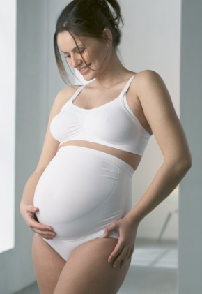 <p>Woman wearing maternaty brief belt in white </p>